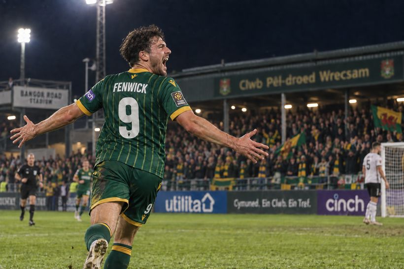 Bobby Fenwick wheels away in celebration under the floodlights