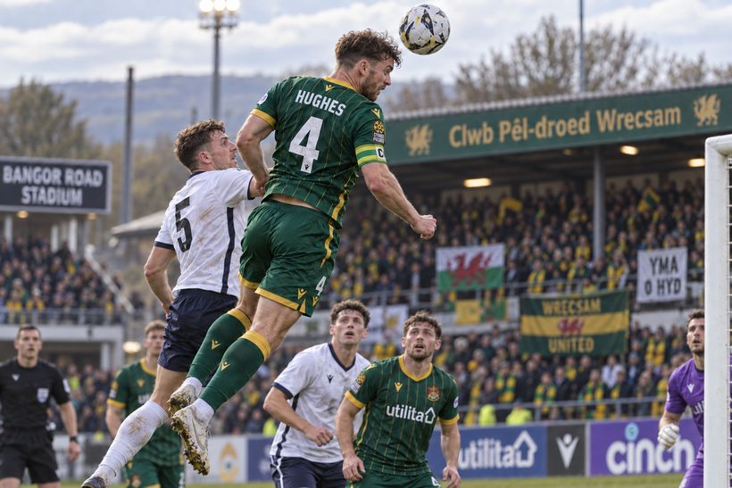 Wrexham United contest a header in front of the Bangor Road terrace